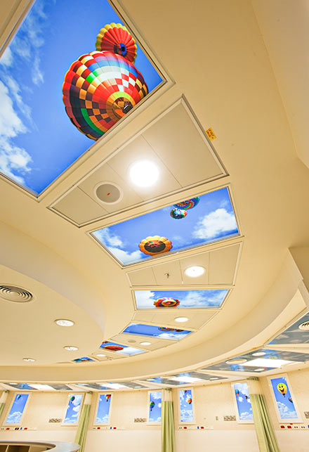 Cheerful balloon SkyCeilings and Luminous Virtual Windows brighten the emergency wing of Western Galilee Hospital.